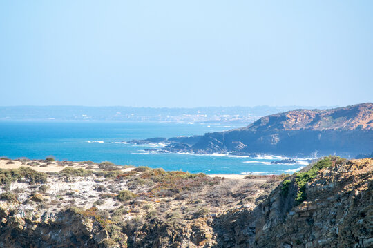 Rugged Coastal Cliffs Overlooking the Azure Ocean Under a Clear Sky