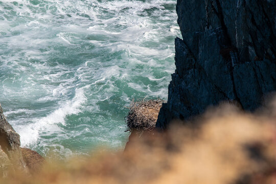 Turbulent Ocean Waves Crashing Against Dark Coastal Cliffs