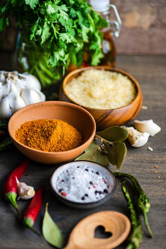 Georgian pilaf spice mix with rice and herbs on rustic table