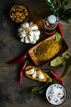 Georgian spice mix with garlic and chili peppers on wooden table