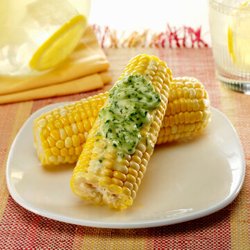 Sweet corn on the cob with parsley chive compound butter