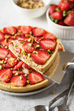 Strawberry Pistachio tart slice with fresh fruit topping