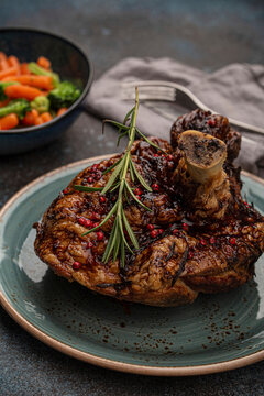 Roasted pork knuckle with rosemary and red pepper berries