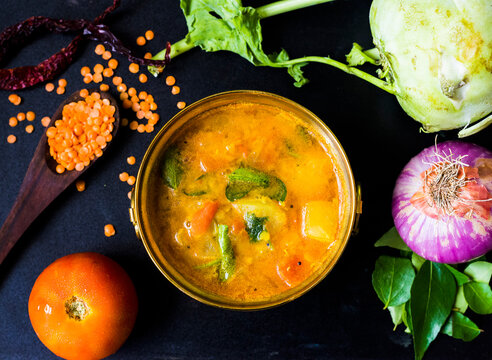 Indian sambhar lentil soup with fresh vegetables and spices