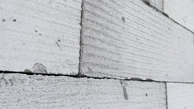 Close up of lightweight concrete block wall texture with mortar line
