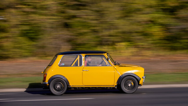 Milton Keynes; UK - Oct. 18th 2026:  1972 yellow Morris Mini Clubman classic car driving on a British road