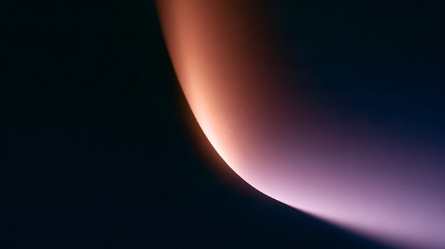 Soft peach glow through curved opening in darkness