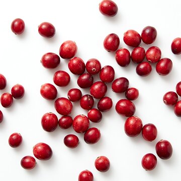 Scattered Fresh Cranberries on a White Background