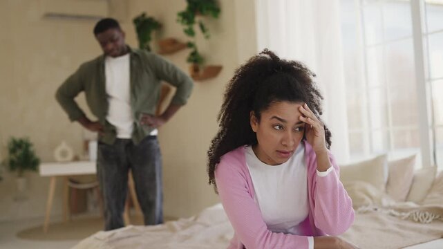 Sad African American woman listens to boyfriend's accusations, feeling hurt