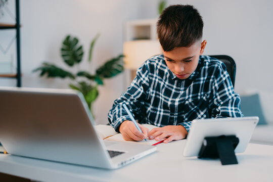 Young student learning from home using technology