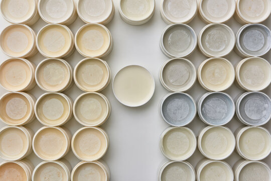 This visually appealing arrangement displays multiple circular containers filled with creamy textures, emphasizing the importance of color variety in product presentation.