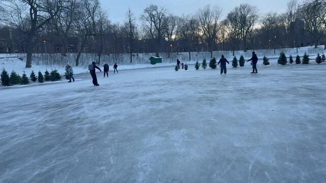 Ice skating on the frozen pond in Parc La Fontaine Montreal