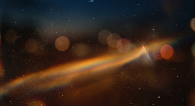A captivating display of abstract light features a colorful spectrum and bokeh effect. The interplay of colors and blurred circles creates a mesmerizing visual experience.