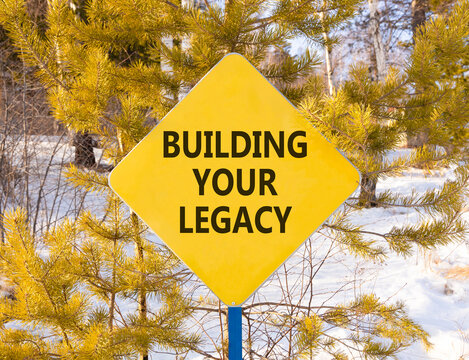 Building your legacy words symbol. Concept words Building your legacy on beautiful yellow road sign. Beautiful winter forest background. Business building your legacy concept. Copy space.