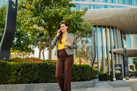 Businesswoman walking in city talking on phone call