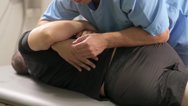 Chiropractic practitioner performing a controlled side-lying manipulation technique to support spinal mobility, flexibility, and physical rehabilitation.