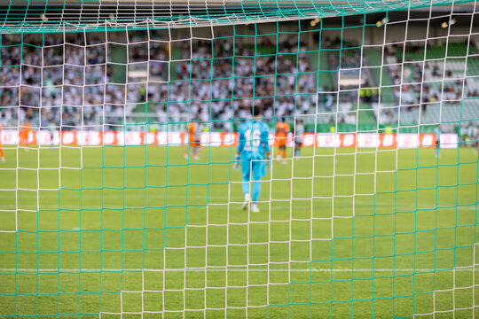 Soccer, football match. Blurred view of football match. Focus on the football net