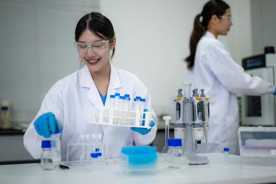 Female scientist conducting laboratory experiment with test tubes and equipment in a research facility