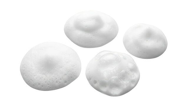 Four dollops of white cosmetic foam isolated on transparent background