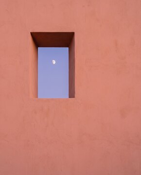 Small Moon Framed by a Window in a Coral Wall