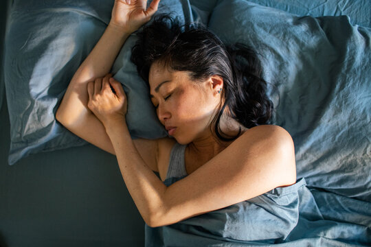 Woman sleeping on her side in bed