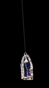 An animated Halloween themed hanging element in a paper-collage style that gently sways on a loop and features spooky ephemera details.
