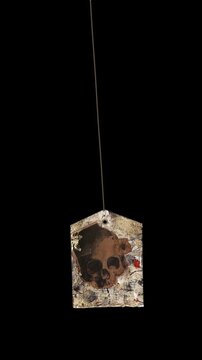 An animated Halloween themed hanging element in a paper-collage style that gently sways on a loop and features spooky ephemera details.
