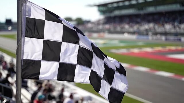 Checkered flag waving beside a motorsport circuit. Finish line, racing victory and competition. Trackside event with spectators. Motorsport celebration.