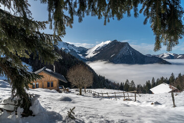 Paysage d' hiver dans les alpages des Bauges , vue sur le hameau du Chargieu , et la Dent d' Arclusaz. avec mer de nuages. Savoie , France  © jeanmichel deborde