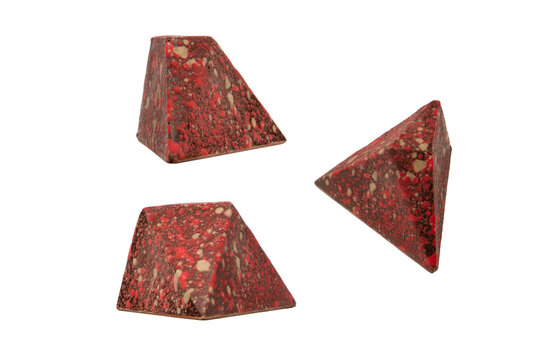 Chocolate candies in the form of precious stones, with marble texture, isolated on a white background.