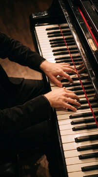 Professional Musician In Black Suit Playing Grand Piano