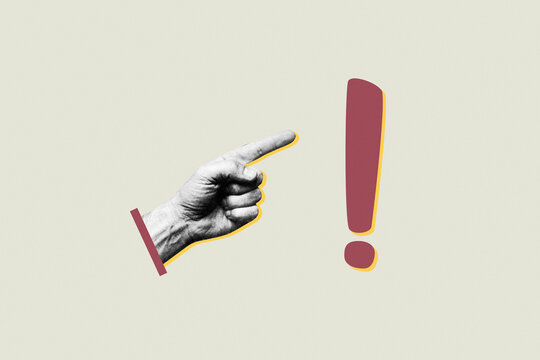 Human hand pointing finger at exclamation mark symbol on minimalist background