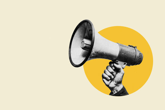 Human hand holding megaphone speaker on yellow circle background