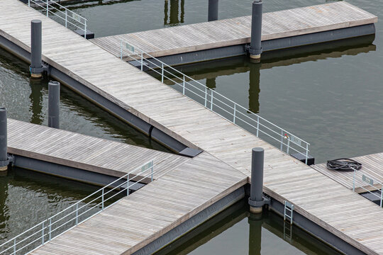 View of the wooden floating docks and piers at Sluishuis in Amsterdam, North Holland, Netherlands.