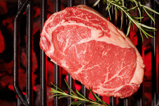 Top view raw ribeye with rosemary