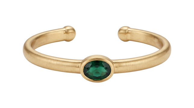 A gold gemstone cuff bracelet with an oval green stone is displayed on a white background jewelry yellow metal