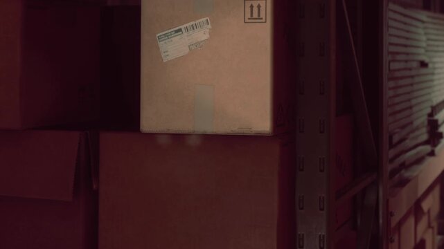 Cardboard boxes sit neatly organized on sturdy metal shelves inside a dimly lit storage warehouse, ready for shipping and inventory management during regular business hours