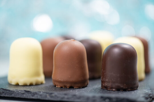 Chocolate teacakes, coated marshmallow treats, krembo, pastry sweets with cookies, fluffy cream and glaze, traditional winter dessert, food selection