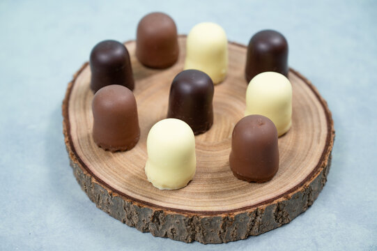 Chocolate teacakes, coated marshmallow treats, krembo, pastry sweets with cookies, fluffy cream and glaze, traditional winter dessert, food selection