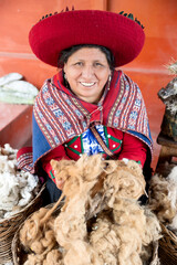 Proud Peruvian woman preserving Andean textile traditions with alpaca wool © Dulúapics