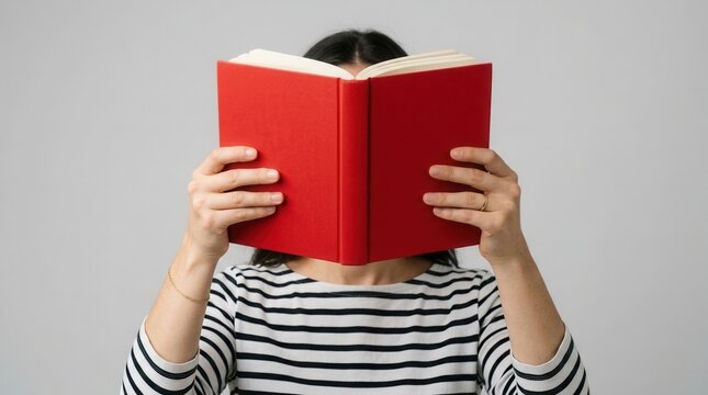 A hand holding a book on an isolated background