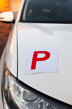 Red p plate on car parked on driveway