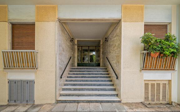 Clean commercial photograph of a typical 1970s apartment building entrance in Athens, ideal for real estate, urban architecture, and residential property features.
