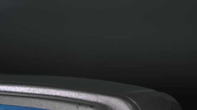 The pop-up flash mechanism in action on an old film camera from the 1990s.