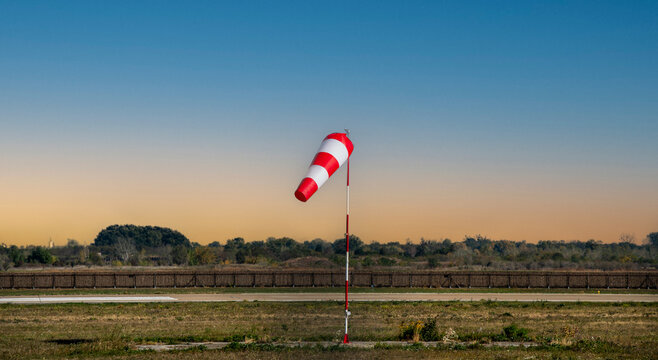 Red and white windsock indicating wind direction at an airport
