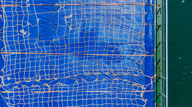 Fishing Net and Blue Tarp on Boat Deck