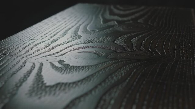 Pulling camera revealing plank studio table sweeping light showing grain seam to reveal sheen