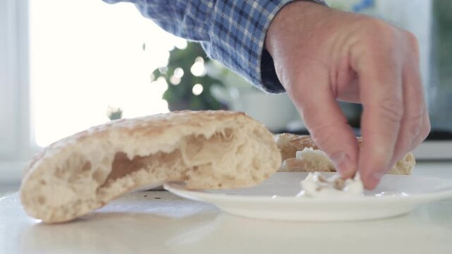 Closeup Shooting with a Hungry Person Eating Fresh Bread with Yogurt, a Refreshing Snack for Breakfast.