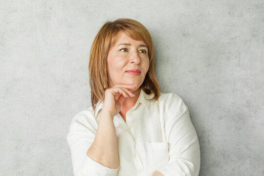 Cute mature red haired woman smiling cheerfully and casually with a positive, happy, confident and relaxed expression