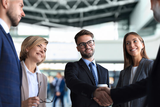 Business people shaking hands, finishing up a meeting.